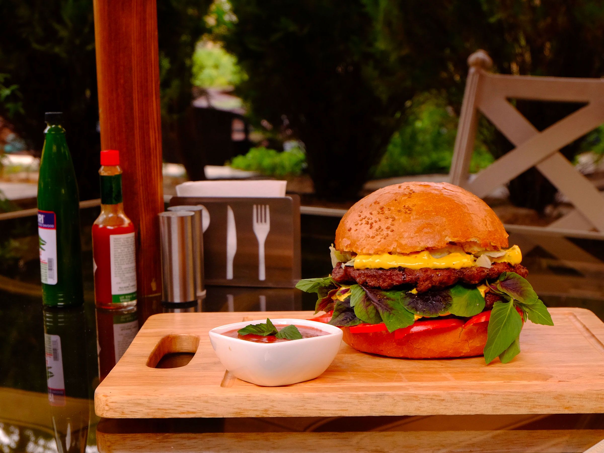 Burger Served On Garden Table